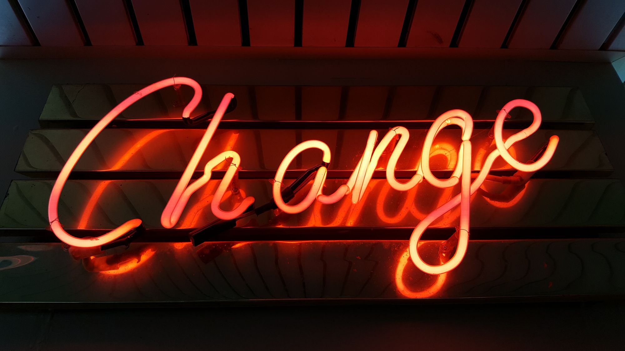 A neon sign reading "change."