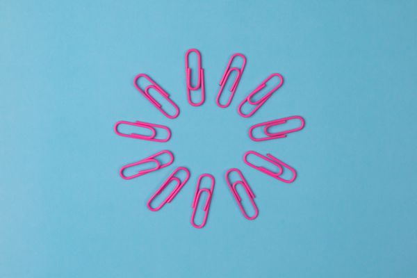 [description: a circle of paper clips on a blue background]