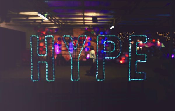 the word "hype" in sequins against a stage-like background